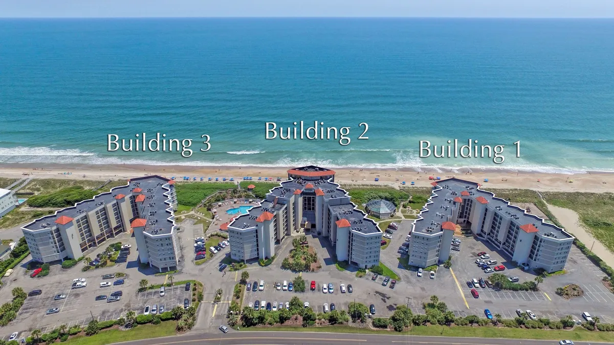 This image shows three buildings of the resort, a large swimming pool, and the adjacent beach. The perspective captures both the inviting pool area and immediate beach access, evoking a sense of relaxation and connection to the ocean—the key inspiration referenced in the section. The open-air setting speaks directly to outdoor wellness routines and the rejuvenating environment.